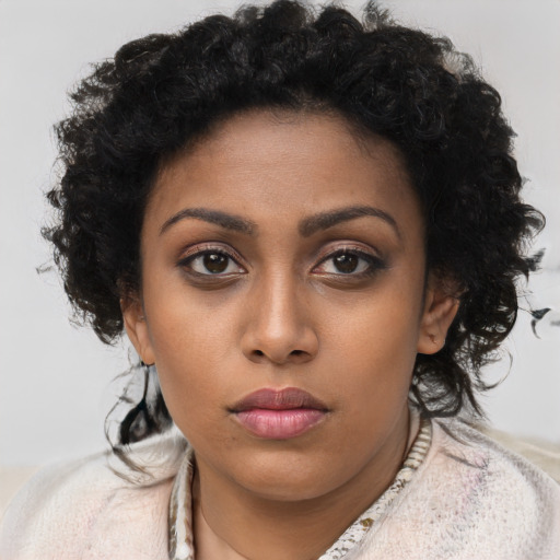Neutral black young-adult female with long  brown hair and brown eyes