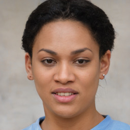 Joyful black young-adult female with short  brown hair and brown eyes