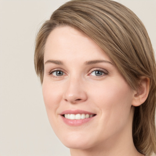 Joyful white young-adult female with medium  brown hair and green eyes