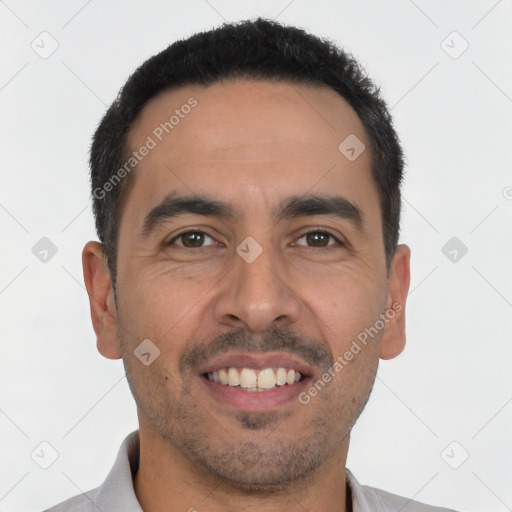 Joyful latino young-adult male with short  black hair and brown eyes