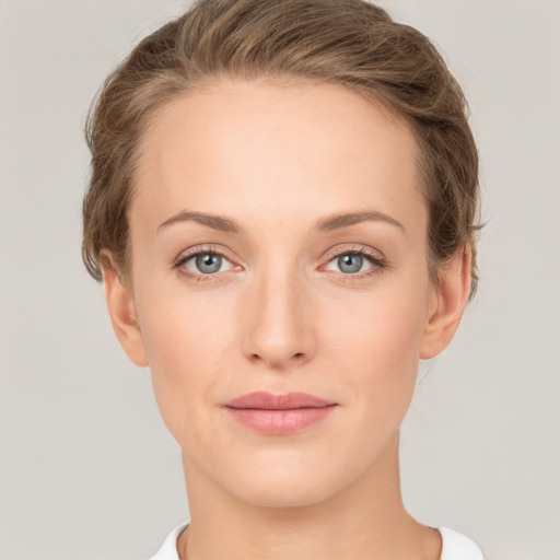 Joyful white young-adult female with medium  brown hair and green eyes