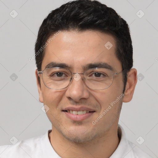 Joyful white adult male with short  black hair and brown eyes