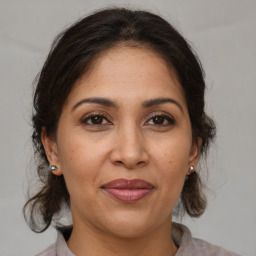 Joyful white adult female with medium  brown hair and brown eyes