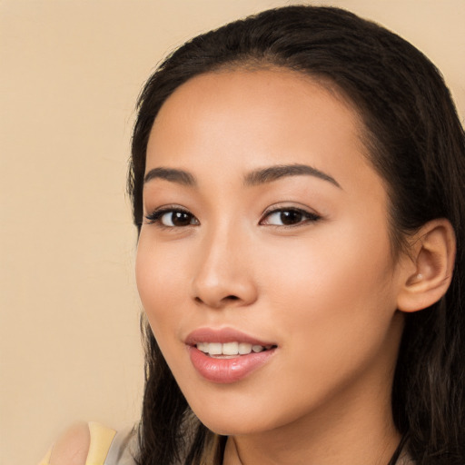 Joyful latino young-adult female with long  brown hair and brown eyes