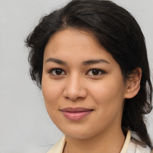 Joyful latino young-adult female with medium  brown hair and brown eyes