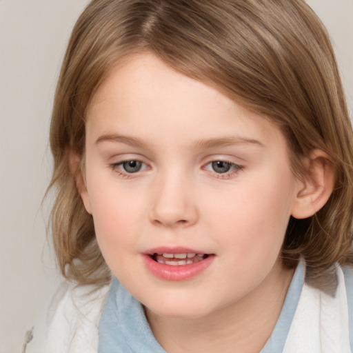 Joyful white child female with medium  brown hair and brown eyes