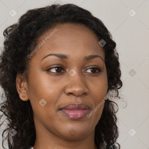 Joyful black young-adult female with long  brown hair and brown eyes