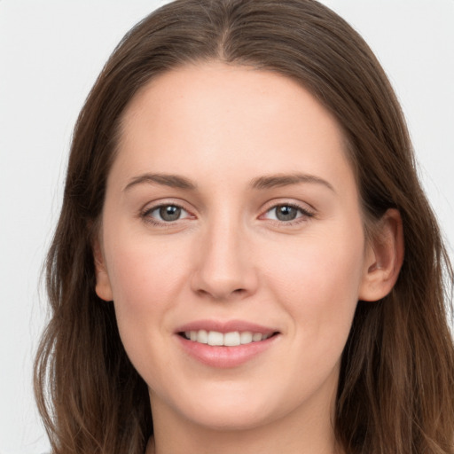 Joyful white young-adult female with long  brown hair and grey eyes