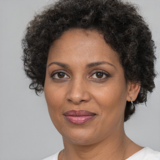 Joyful black adult female with short  brown hair and brown eyes