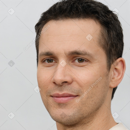 Joyful white adult male with short  brown hair and brown eyes