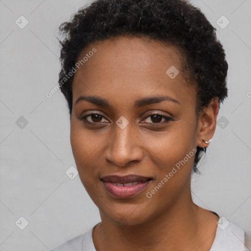 Joyful black young-adult female with short  black hair and brown eyes