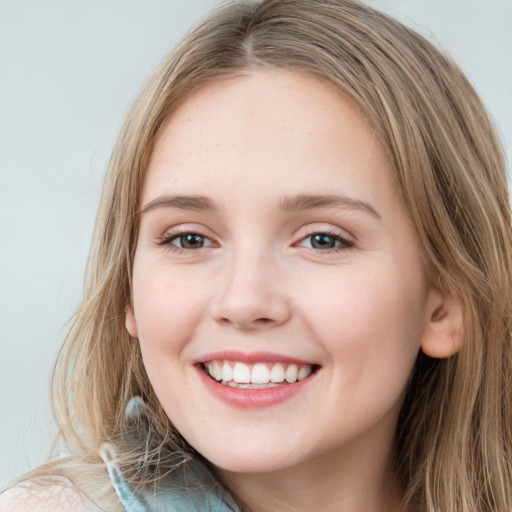 Joyful white young-adult female with long  brown hair and green eyes