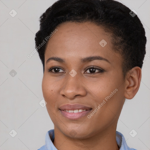 Joyful black young-adult female with short  brown hair and brown eyes