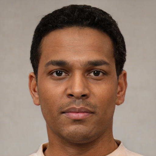 Neutral latino young-adult male with short  black hair and brown eyes