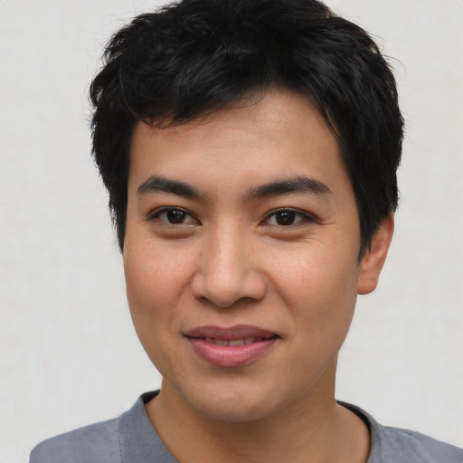 Joyful asian young-adult male with short  black hair and brown eyes