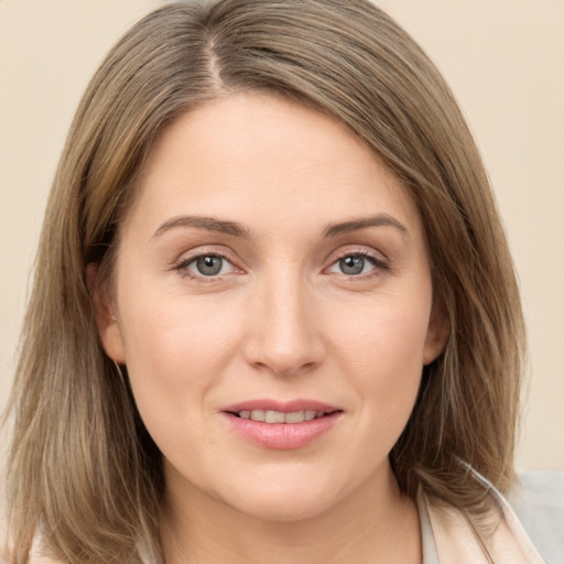 Joyful white young-adult female with medium  brown hair and grey eyes