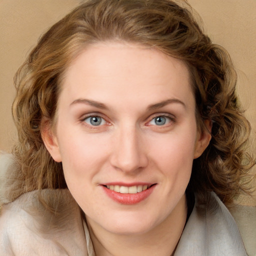 Joyful white young-adult female with long  brown hair and green eyes