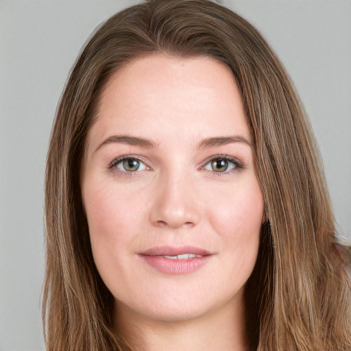 Joyful white young-adult female with long  brown hair and green eyes