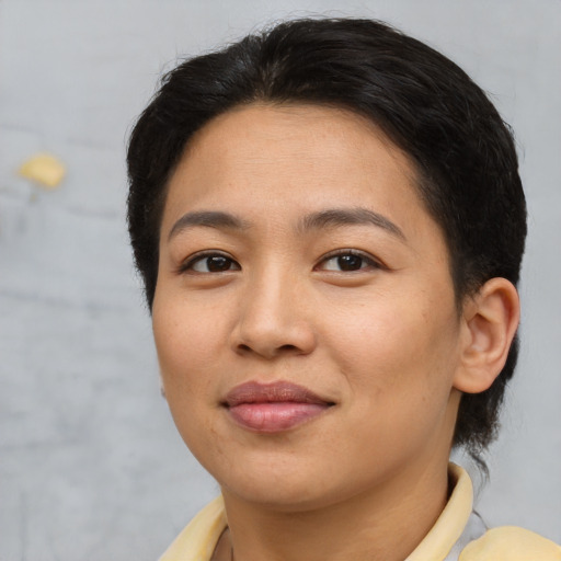 Joyful asian young-adult female with short  brown hair and brown eyes