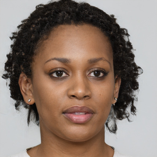 Neutral black young-adult female with medium  brown hair and brown eyes