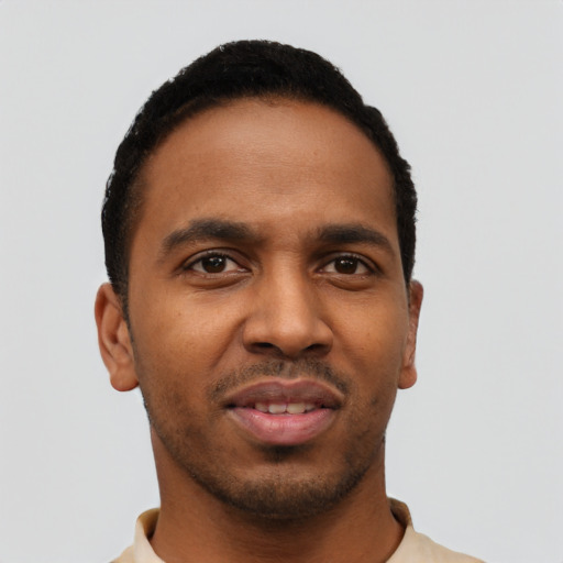 Joyful black young-adult male with short  black hair and brown eyes