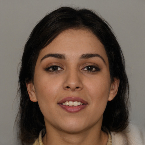 Joyful white young-adult female with long  brown hair and brown eyes