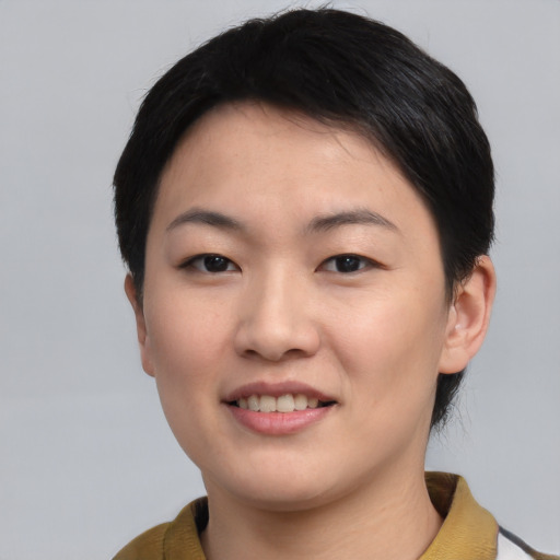Joyful asian young-adult female with short  black hair and brown eyes