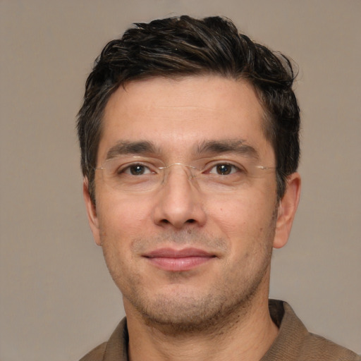 Joyful white adult male with short  brown hair and brown eyes