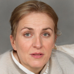 Joyful white adult female with medium  brown hair and blue eyes