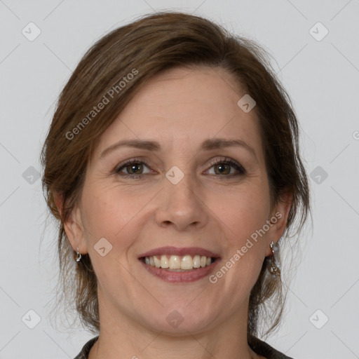 Joyful white adult female with medium  brown hair and grey eyes