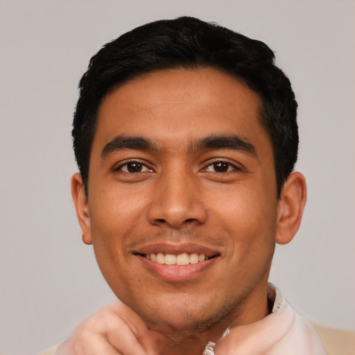 Joyful latino young-adult male with short  black hair and brown eyes