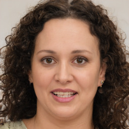 Joyful white adult female with long  brown hair and brown eyes