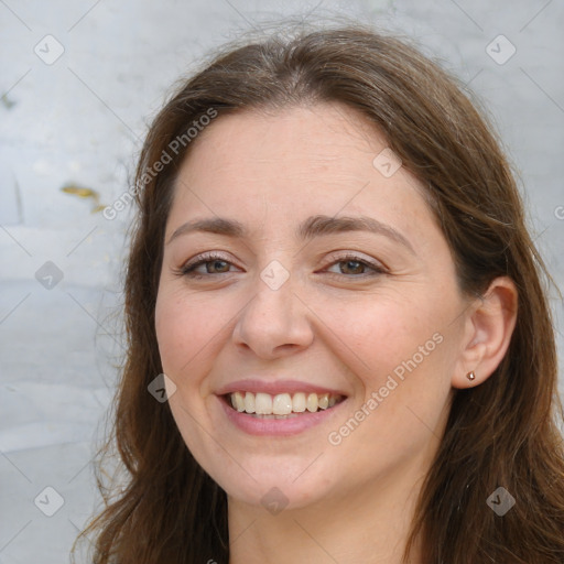 Joyful white adult female with long  brown hair and brown eyes