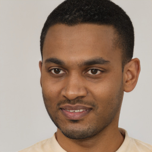 Joyful black young-adult male with short  black hair and brown eyes