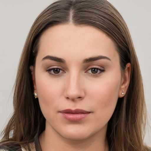 Neutral white young-adult female with long  brown hair and brown eyes