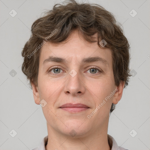 Joyful white adult male with short  brown hair and grey eyes