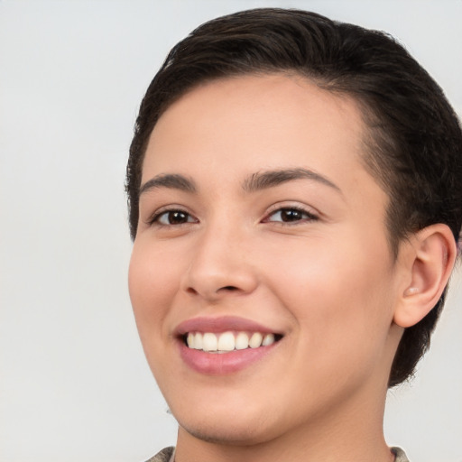 Joyful white young-adult female with short  brown hair and brown eyes