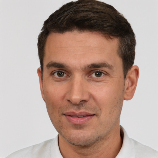 Joyful white young-adult male with short  brown hair and brown eyes