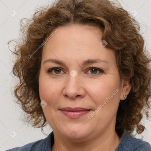 Joyful white adult female with medium  brown hair and blue eyes