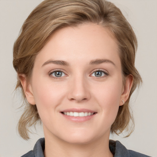 Joyful white young-adult female with medium  brown hair and blue eyes