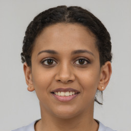 Joyful latino young-adult female with short  brown hair and brown eyes