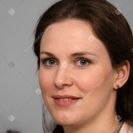 Joyful white adult female with medium  brown hair and grey eyes