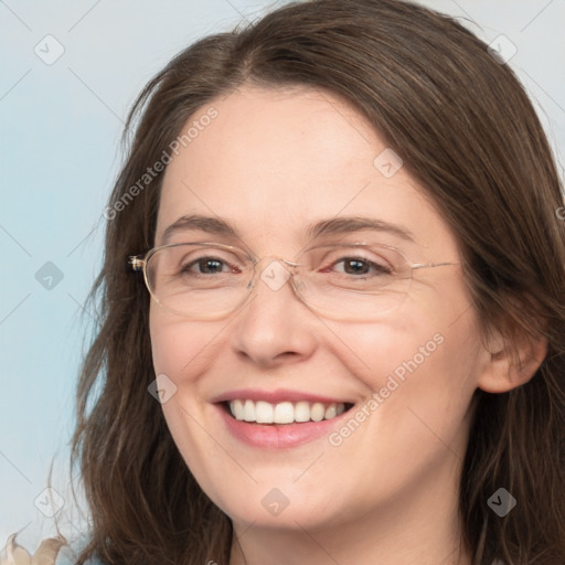 Joyful white adult female with long  brown hair and grey eyes