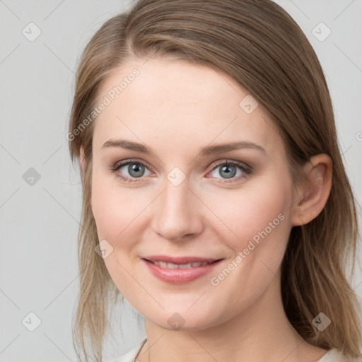 Joyful white young-adult female with medium  brown hair and blue eyes