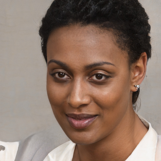 Joyful latino young-adult female with short  black hair and brown eyes