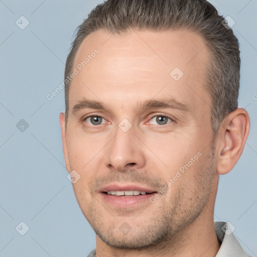 Joyful white adult male with short  brown hair and brown eyes