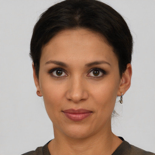 Joyful latino young-adult female with short  brown hair and brown eyes