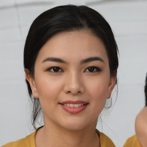 Joyful latino young-adult female with medium  black hair and brown eyes