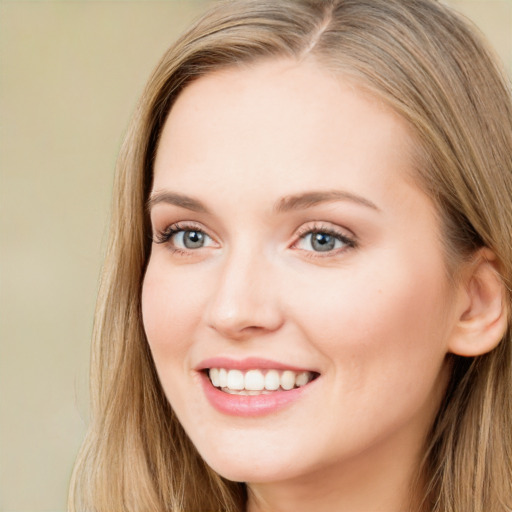 Joyful white young-adult female with long  brown hair and blue eyes