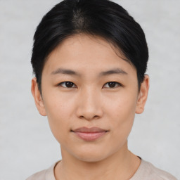 Joyful asian young-adult female with short  black hair and brown eyes